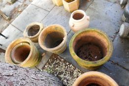 Eight various sized terracotta circular planters