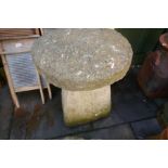 A pair of weathered stone effect staddle stones