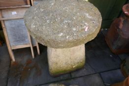 A pair of weathered stone effect staddle stones