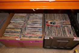 Four large boxes containing various single records various genres