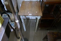 An Edwardian mahogany revolving bookcase and oak coffee table on painted base