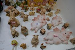 A selection of Piggins figurines, some boxed and various other pig figurines and plaques