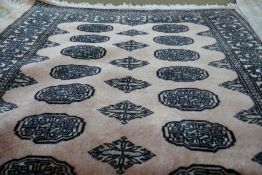 A middle eastern pink ground carpet with elephant pad decoration