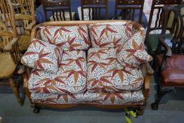 Vintage Bergere two seat sofa with carved arms on claw and ball supports