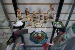 A shelf of Goebel & Hummel figures - Limoge trinket dishes, a Moorcroft ashtray and a pair of vintag