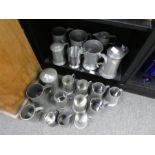 A collection of pewter tankards, jugs, etc some by quart