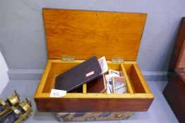 A box containing assorted cigarette cards, an autograph book relating to former football players and