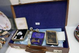 Vintage leather case containing Masonic items, including aprons, medals, Mother of Pearl opera binoc