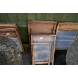 Large collection of antique washboards, copper dollies, stools etc, some branded