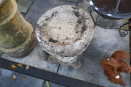 Weathered stone effect bird bath on scalloped plinth