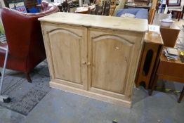 A stripped pine 2 door kitchen cupboard fitted with shelves by Paul Martyn