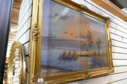 A gilt framed oil on canvas depicting duck over water by G. Brouwer