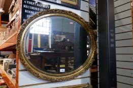 A vintage gold framed oval bevelled mirror