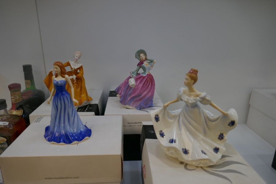 A selection of four Royal Doulton figures depicting ladies in fine dress: Kathy, Sapphire, Kirsty &