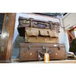 A selection of vintage leather suitcases, mailbag and camping bag