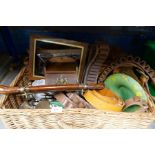 A wicker hamper containing leather ammo belt, wooden box with brass crest, silver plated cutlery