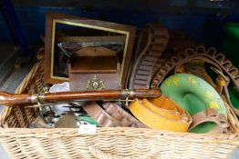 A wicker hamper containing leather ammo belt, wooden box with brass crest, silver plated cutlery