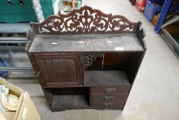 A vintage mahogany hanging wall unit with cupboards, drawers and open shelfs