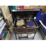 A vintage oak cased record cabinet 'Natural tones' fitted with record player and selection of LPs