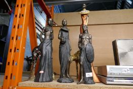 Four models of African women - some Leonardo collection and two giraffes