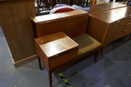 A mid century teak drop leaf rectangular dining table and telephone seat by original chippy telephon