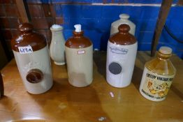 Six stoneware bottles including Timothy Whites, Taylors and Creedy Vintage Cider examples