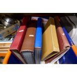 A crate containing stamp albums, British and Commonwealth and other World stamps