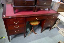 A larger mahogany knee hole desk with red leather insert above 2 slide and 7 drawers, by Golden Key,