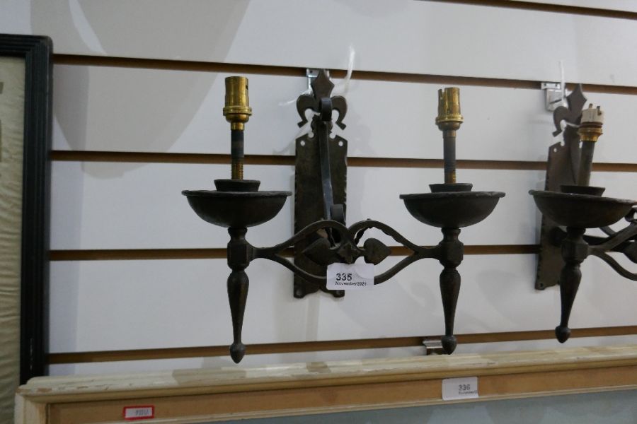 A pair of Art Nouveau iron wall lights