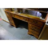 A reproduction twin pedestal desk having eight drawers