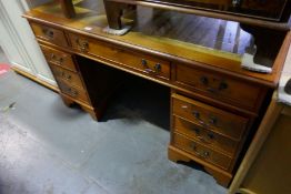 A reproduction twin pedestal desk having eight drawers