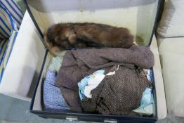 An old blue suitcase containing textiles