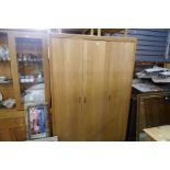 A contemporary oak three door wardrobe and a pair of matching bedside chests and a 6 drawer chest