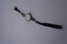 Vintage 9ct yellow gold watch with enamel dial with blue and red numbers, marked 375, graved with in