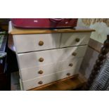 A modern painted two door wardrobe, a pair of matching bedside chests and a small chest of drawers