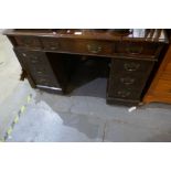 An antique oak twin pedestal desk having nine drawers