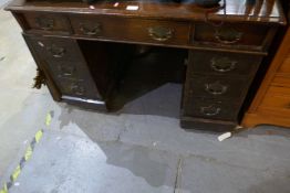 An antique oak twin pedestal desk having nine drawers