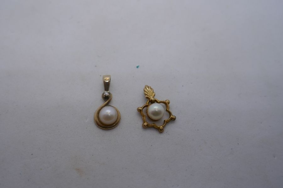 Two 9ct gold pendants, one set with a diamond chip and pearl and the other a single pearl, both mark