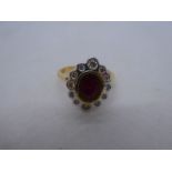 Pretty 18ct yellow gold cocktail ring with central oval ruby surrounded by 12 round cut diamonds, ma