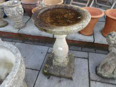 Weathered stone effect bird bath and a water feature in the form of a boy