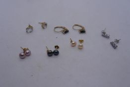 Collection of 10k and other stud earrings to include pearl stud examples