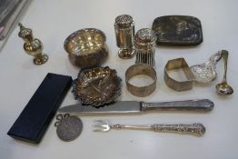 A mixed silver lot comprising peppers, napkin rings, cigarette case, trinket dishes, etc and a Victo