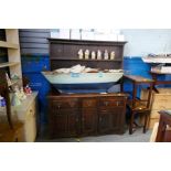 A vintage oak dresser with open rack above 3 drawers and cupboards, 152 cm
