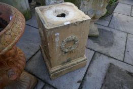 A Victorian square garden pedestal having wreath decoration