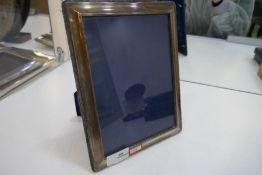 A silver photoframe, Sheffield 2001 Carr's of Sheffield Ltd, 24cm x 19cm approx. Also with a silver