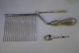 A small sterling Canadian decorative teaspoon with a Mother of Pearl handled silver fork and silver