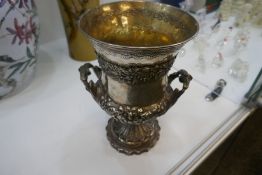 WITHDRAWN A very impressive Georgian silver chalice with foliate and floriated repoussed design