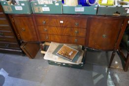 A reproduction mahogany side board having three central drawers