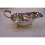 Edwardian silver sauce boat with scalloped design rim and three paw feet. Hallmarked Chester 1905 Wi