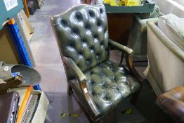 A reproduction green leather open armchair